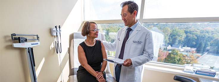 Neurosurgeon Kevin Yao, MD, sees a patient during a follow-up visit.